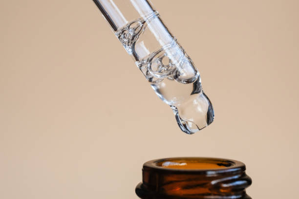 istock A liquid cosmetic pipette and an amber bottle on a beige background. 1475383895
