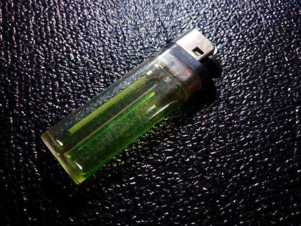 istock Focused Gas Lighter Match on Black Wrinkled Surface 1475385560