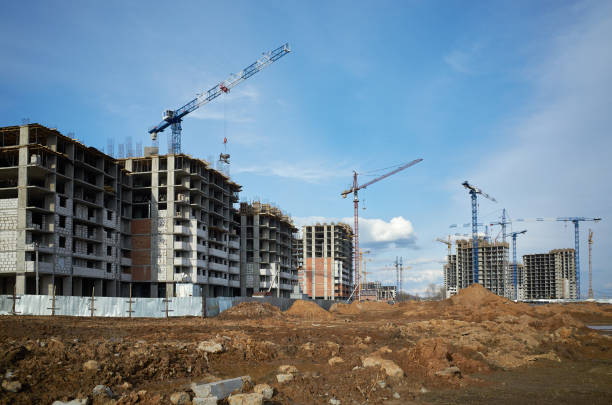 istock Tower cranes and high-rise buildings under construction at construction site at blue clean sky 1475385887