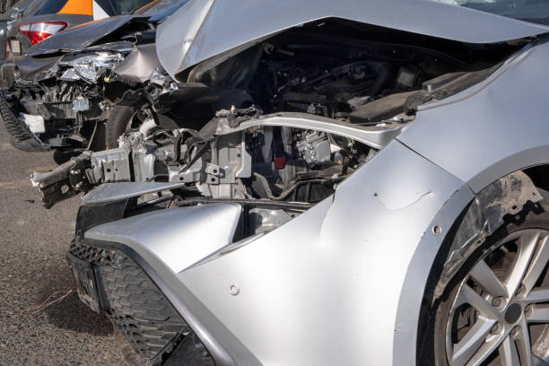 istock Dented Car front bumper and light lamp. Crashed metall on private car. Car insurance Transport concept. 1475386961