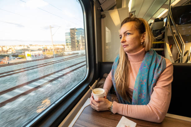istock A woman is sitting in a train. 1475387082