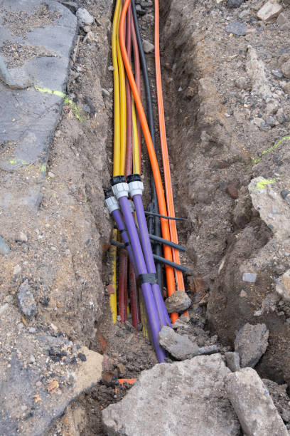 istock underground electric cable infrastructure installation. Construction site with A lot of communication Cables protected in tubes. electric and high-speed Internet Network cables are buried underground on the street 1475387092