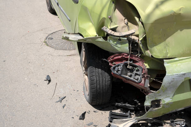 istock Dented Car bumper and rear light lamp. Transportation Crashed metall on private car. Car insurance concept. Green Metallic color 1475387153