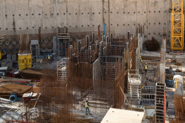 istock Beginning Laborers work Concrete pillars on the construction site of a modern skyscraper in Israel. Reinforcing concrete with metal iron mesh on construction site. Urban development concept. 1475387194