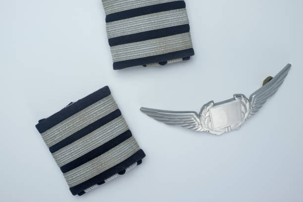 Flatlay closeup of first officer epaulettes and a aviator badge. stock photo