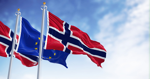 flags of Norway waving with European Union flag on a clear day. Democracy and politics. Rippled textile, 3d illustration render. Selective focus