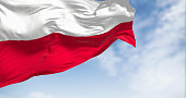 The national flag of Poland waving in the wind on a clear day