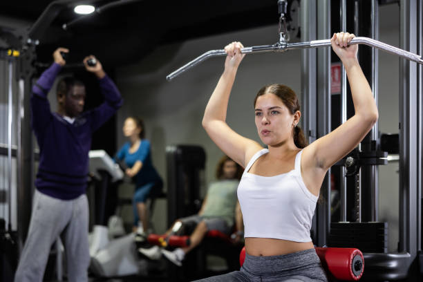 istock Woman is engaged in a simulator for development of back muscles 1475391604