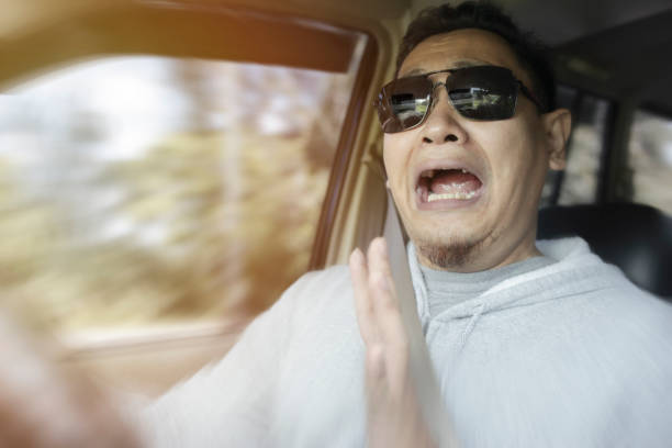 Portrait of male Asian driver shocked and panic about to have crash accident, zoomed motion blur defocus Portrait of male Asian driver shocked and panic about to have crash accident, zoomed motion blur defocus concept car burnout stock pictures, royalty-free photos & images