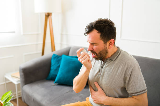 istock Ill man suffering from asthma using an inhaler 1475394127