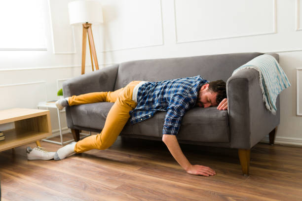 istock Caucasian man looking tired sleeping on the couch 1475394886
