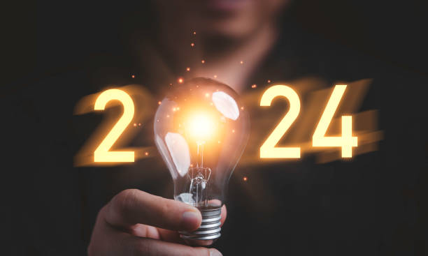 istock Businessman holding glowing lightbulb with 2024 number for creative thinking idea for start new business concept. 1475395040