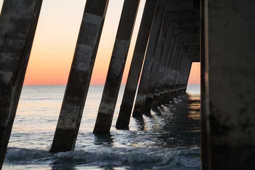 A concrete pier foundation at sunrise on Wrightsville Beach.