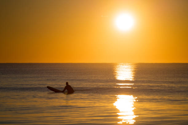 istock Surfer Waiting for the Next Wave at Sunrise 1475396097