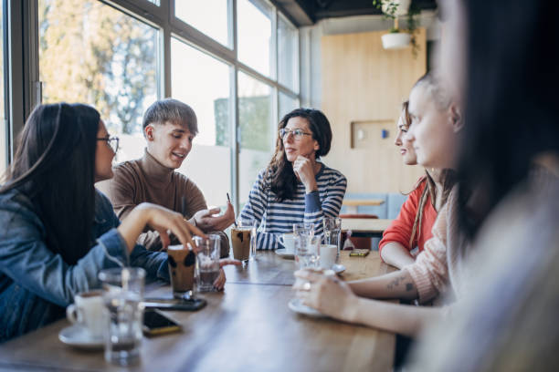 istock Friends sitting together in cafe 1475399790