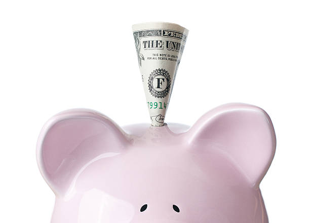 istock pink piggy bank with dollar on white background, Saving 147540032