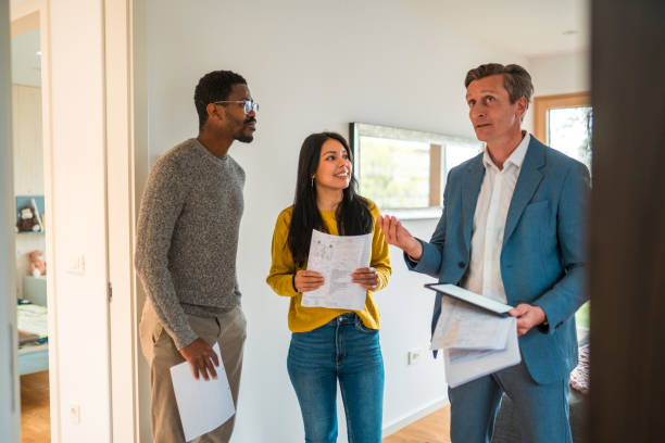 Future House Owners Indoors Doing A Visit With A Real Estate Agent stock photo