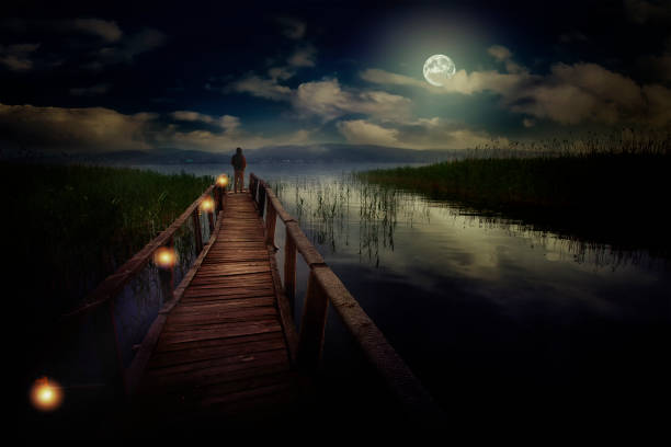 istock Earth, moon, water, clouds, wooden pier, man and ecological environment 1475403909