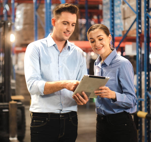 istock Storehouse supervisor worker and logistic engineer standing together at storage room. 1475413013