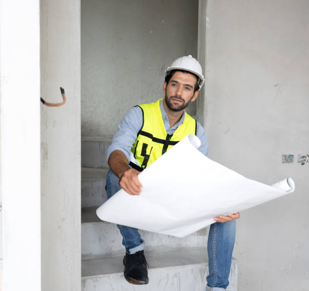 istock Professional architect wears safety hardhat is working on home interior and housing development project. 1475414047