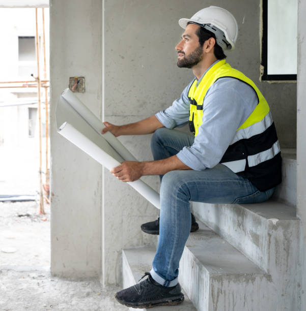 istock Professional architect wears safety hardhat is working on home interior and housing development project. 1475414048
