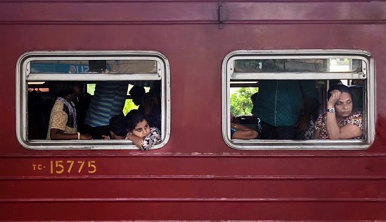 Colombo, Sri Lanka,  August 23, 2018:  The train is an important commuting tool for Colombo people.  But the trains are usually so crowded that some people hang from the doors