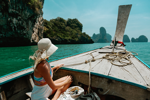 Young Caucasian woman in Thai Taxi boat in Krabi, Thailand