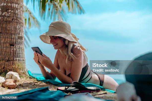 Woman Relaxing At Beach On Chair With Electronic Book Reader Stock Photo - Download Image Now