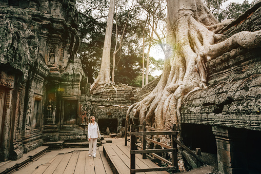 Traveler Exploring Ancient Ruins of Ta Prohm Temple at Angkor