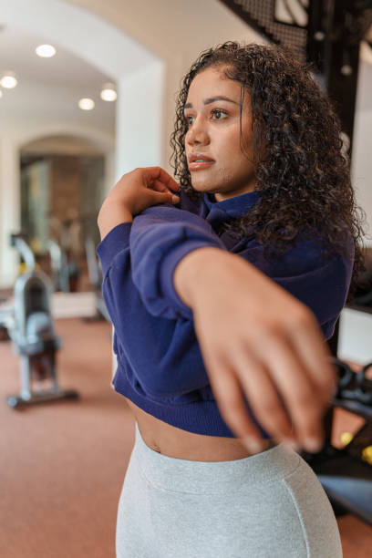 istock Woman doing warm up exercises at the gym 1475426012