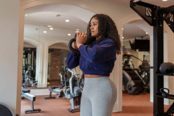 istock Woman doing kettlebell workout at the gym 1475426013