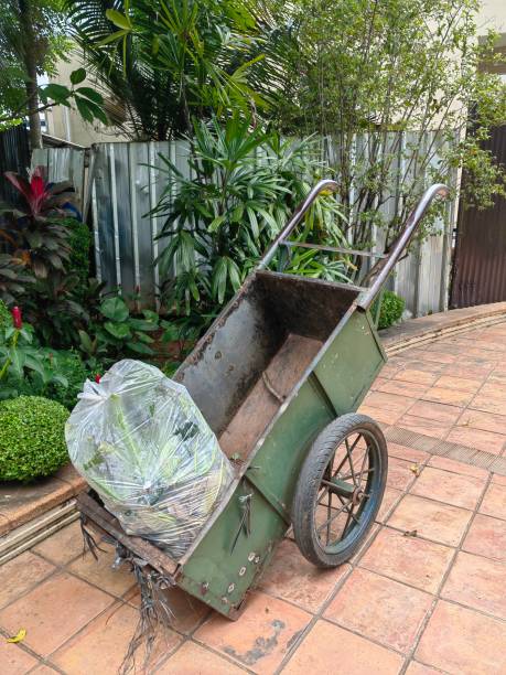 istock Green cart carrying garbage. 1475429437