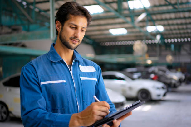 istock Young entrepreneur work at car garage. 1475430312