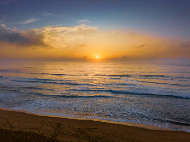 istock Summer sunrise at the seaside with clouds and haze 1475437127
