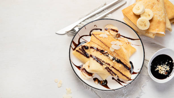istock Homemade crepes, tasty thin pancakes with chocolate and nuts. 1475437552