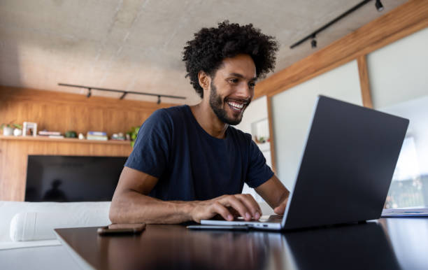 istock Happy man working at home on his laptop 1475437751