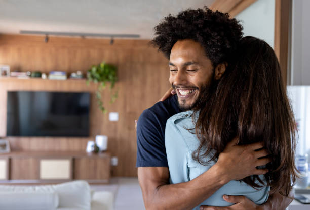 istock Happy couple hugging at home 1475437784
