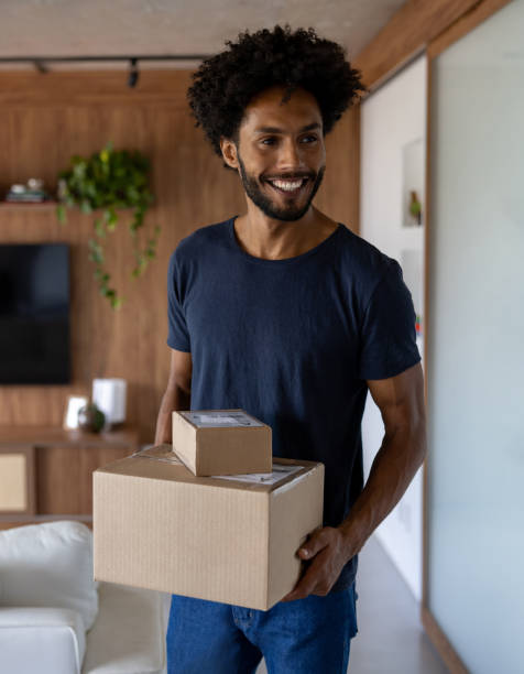 istock Happy man at home receiving some packages in the mail 1475437788