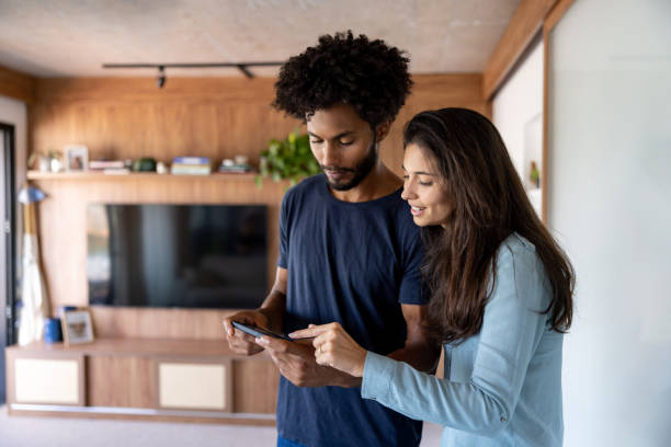 istock Couple controlling their smart home from their cell phone 1475437833