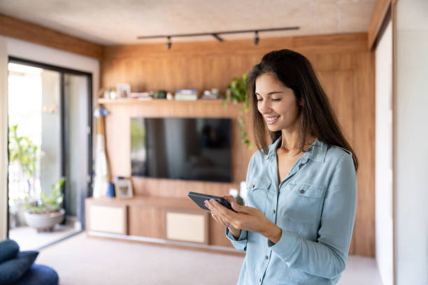 istock Happy woman at home  using her cell phone 1475437837