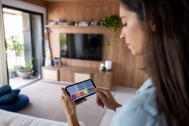 istock Woman using a mobile app on her cell phone to control her smart home 1475437849
