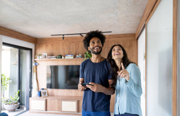 Couple controlling the lights in their house using an automated system