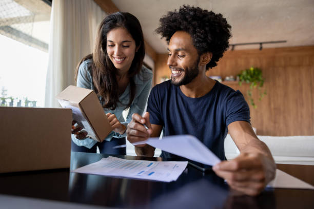 istock Happy couple running their e-commerce business from home 1475438364
