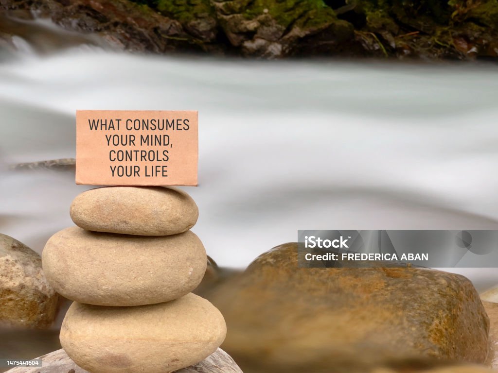 Inspirational Quote Motivational inspirational quote. What consumes your mind, control your life on paper with nature background Mindfulness Stock Photo