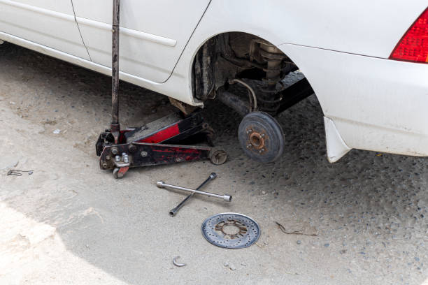 istock Changing car rear wheel lifted by hydraulic jack 1475444937