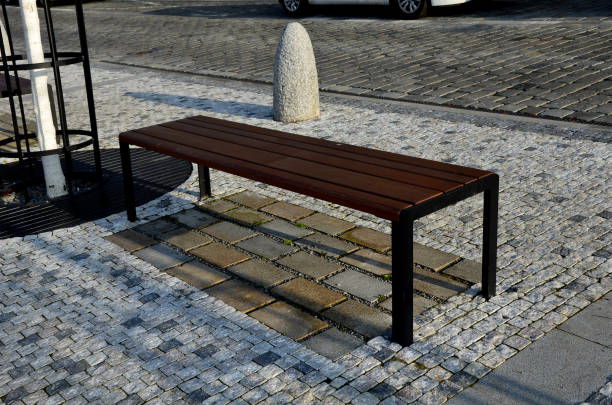 istock stone barriers in a square shaped cylinder with a hemisphere on top. granite curbs as stops at the parking lot. chain decorative fence against a colony of pedestrians and vehicles with a stone bollard 1475450555