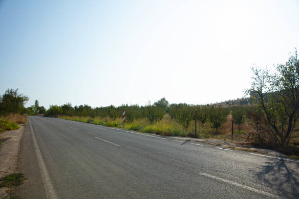 istock Asphalt road leading to the village 1475451882