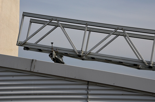 aluminum footbridge for washing windows above the skylight. simplifying the washing of large greenhouses and galleries with ceiling windows. the ladder can be moved over the rails, blue sky, trowel, metal, tracks