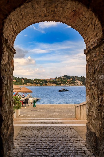 Stone arch overlooking the Mediterranean Sea in the Old Town of Villefranche sur Mer on the French Riviera, South of France