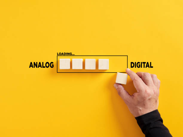 istock Transition of technology from analog to digital. Technological transformation. Hand places a wooden cube to the loading bar with the words analog and digital. 1475453879